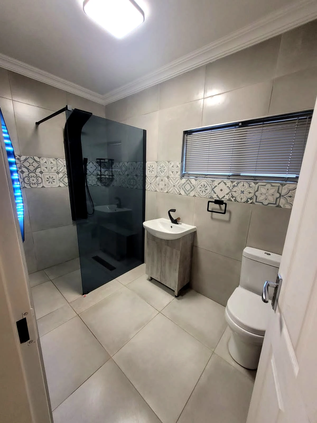 Compact shower bathroom renovation with modern finishes