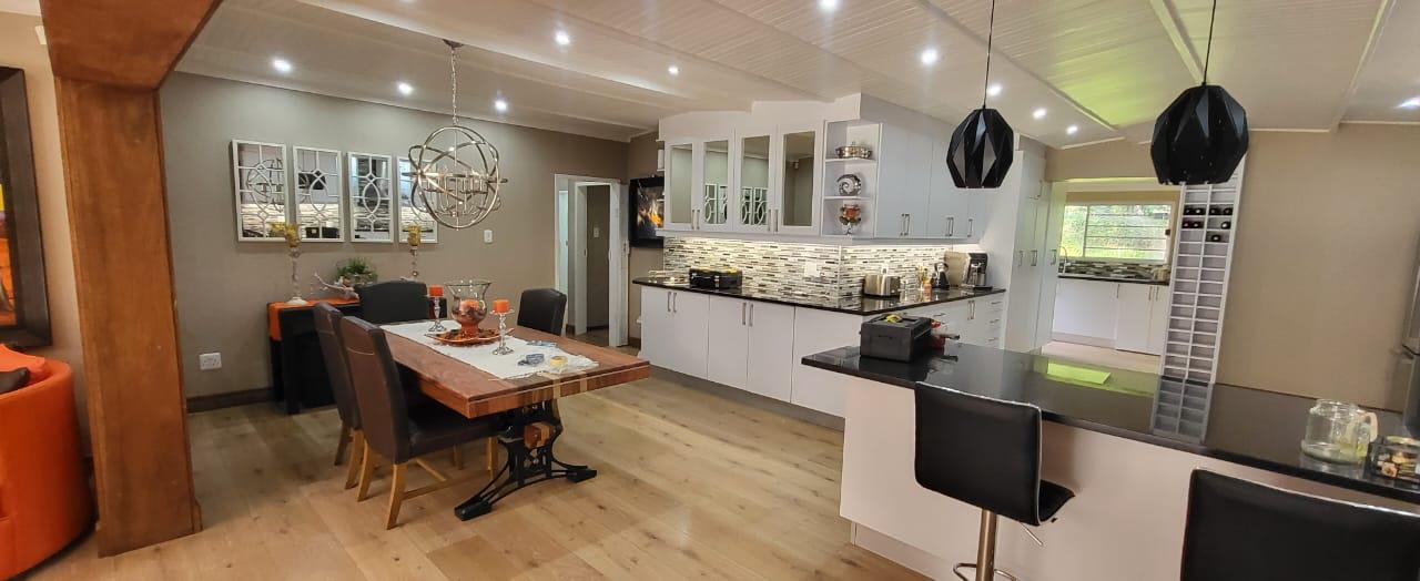 Kitchen and dining room interior with modern lighting design