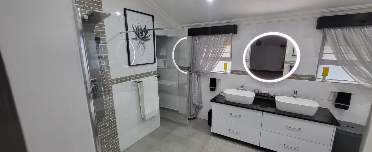 White bathroom vanity and shower renovation